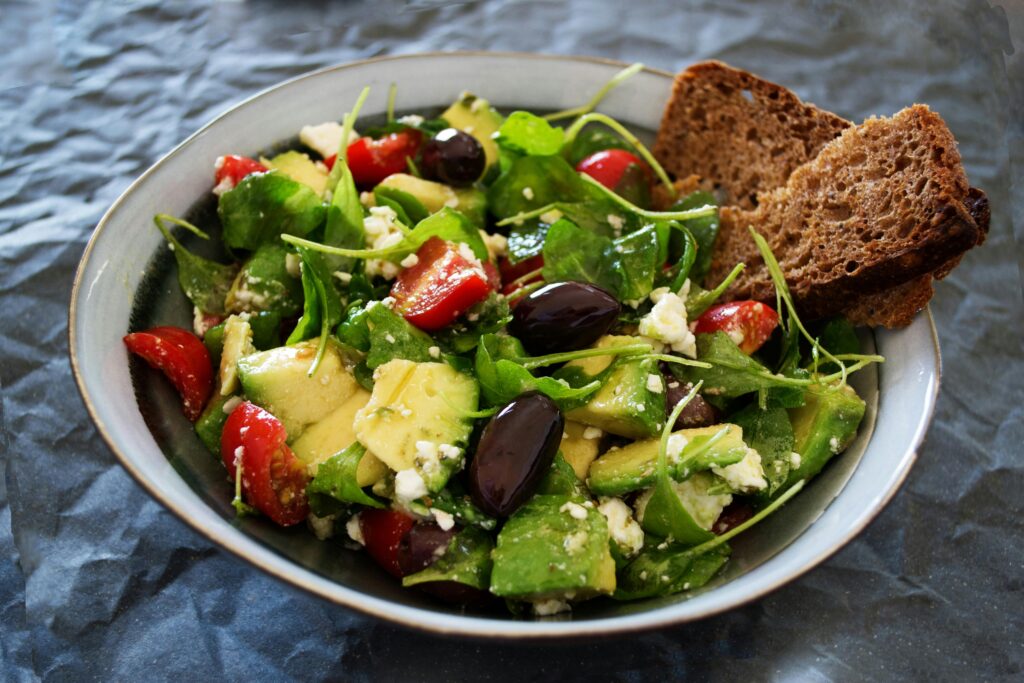 Delicious Greek-style salad with avocado, feta and olives, representing a colourful longevity-friendly meal.